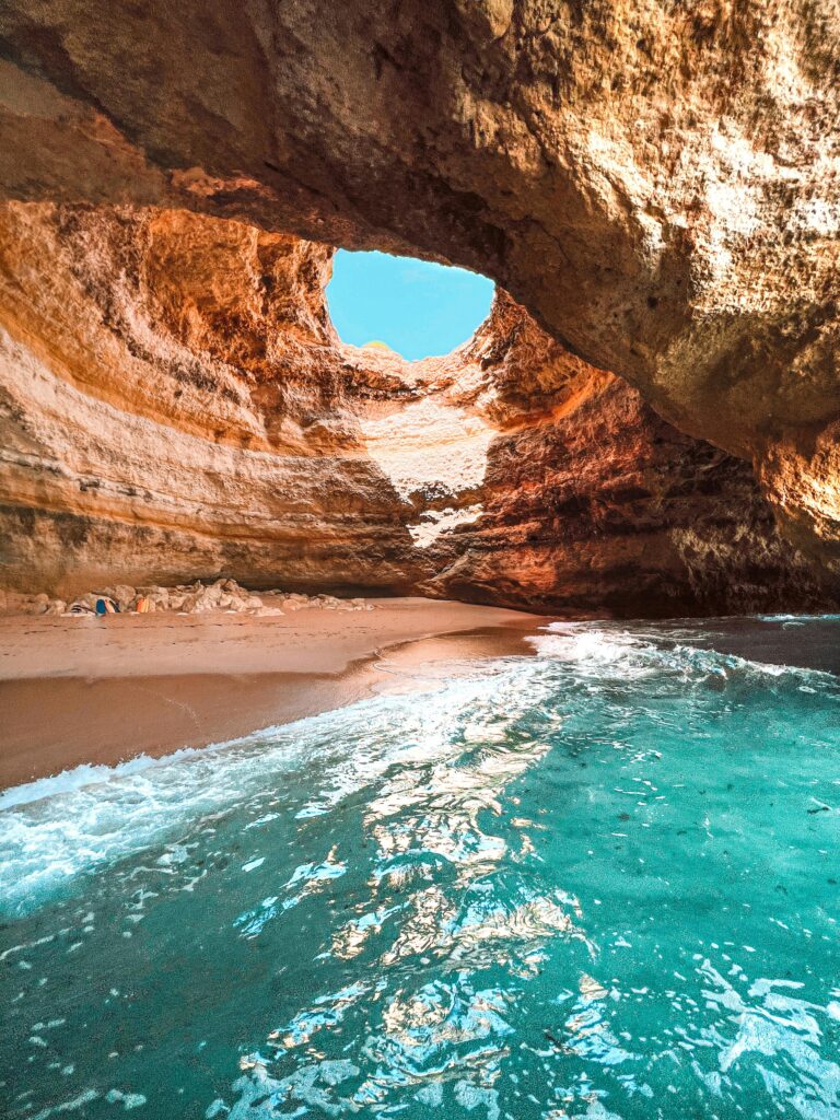 Explore the stunning Benagil cave with its natural skylight and crystal clear waters in Algarve, Portugal.